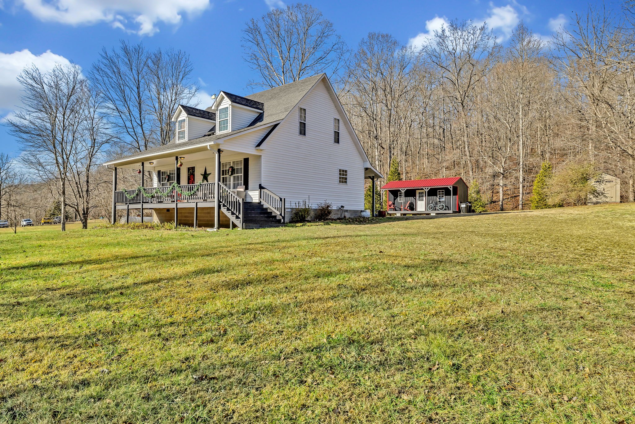 293 Slippery Road Hohenwald, TN 38462 - Photo 5 of 36 a view of a house with a yard and sitting area