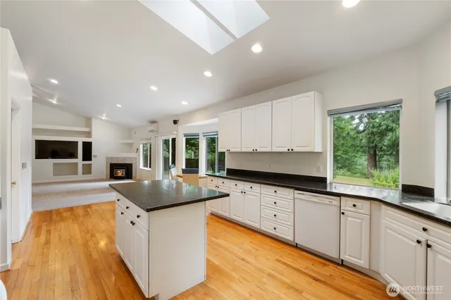 a kitchen with granite countertop a sink and cabinets