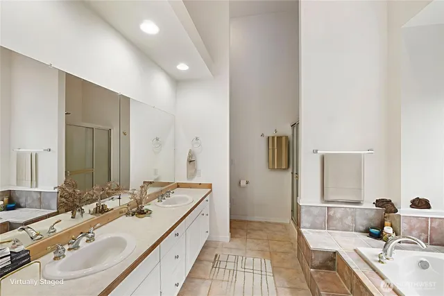 a bathroom with a double vanity sink and mirror