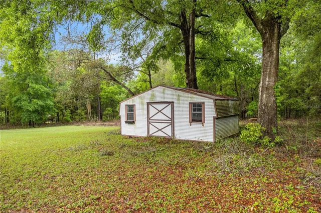 a view of a barn in the middle of a yard