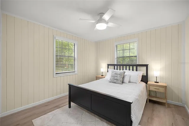 a bedroom with a large bed and a chandelier