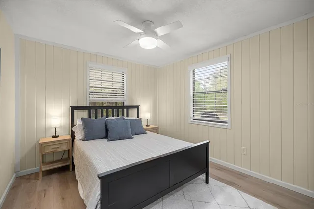 a view of a bedroom with baby crib and lounge chair
