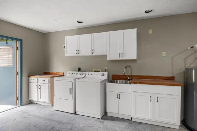 a view of an empty room with closet and windows