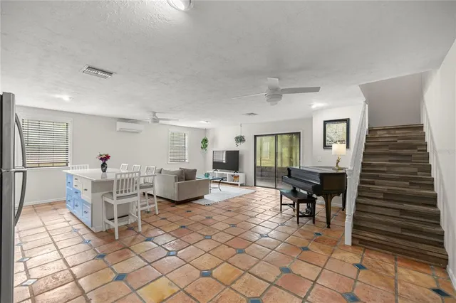 a kitchen with stainless steel appliances a refrigerator a stove a dining table and chairs