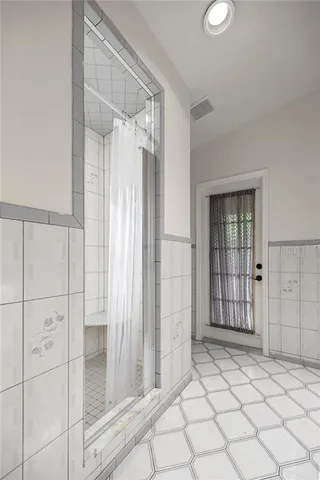 a view of a house with a lush green forest