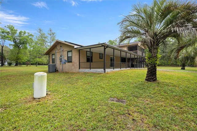 a front view of a house with a yard garage and outdoor seating