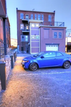 a car is parked in front of a brick building