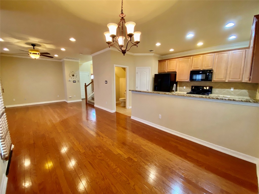 6704 Menchaca Road, Unit 8 Austin, TX 78745 - Photo 38 of 39 a view of a kitchen with a sink and chandelier