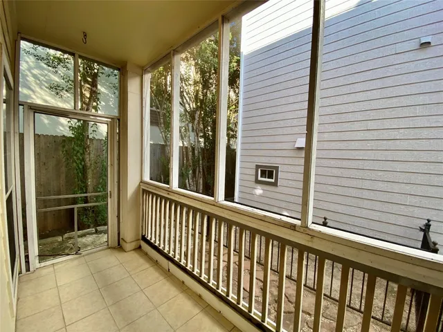 an empty room with a ceiling fan and a window