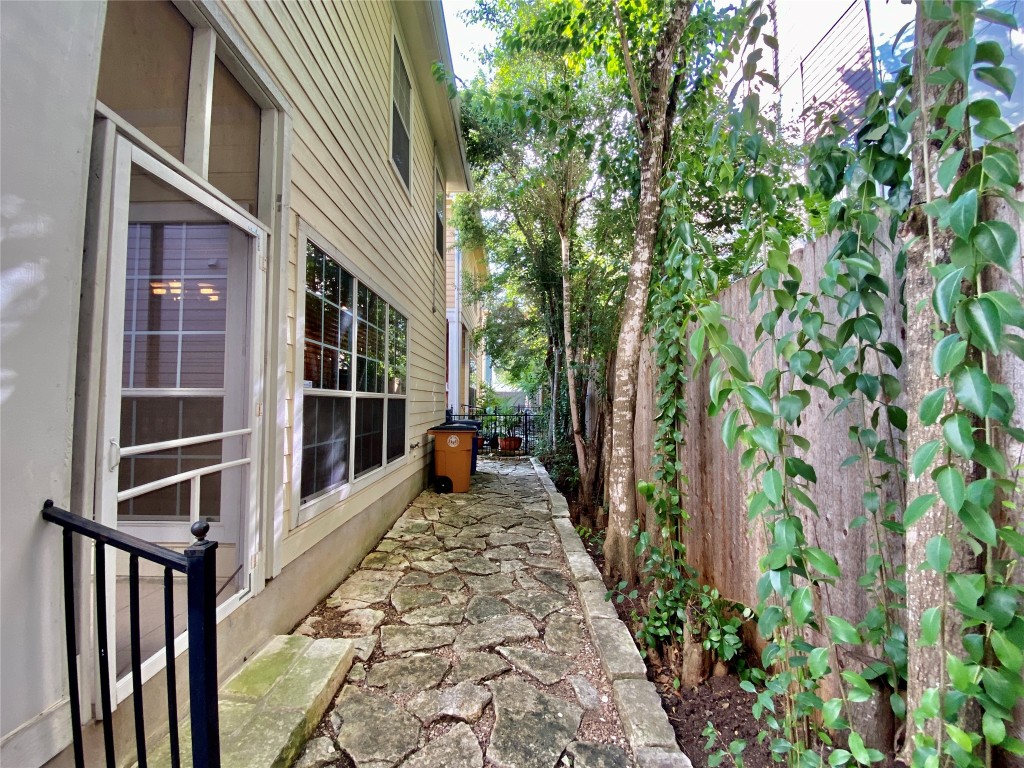 6704 Menchaca Road, Unit 8 Austin, TX 78745 - Photo 15 of 39 a view of a house with a large window and wooden fence