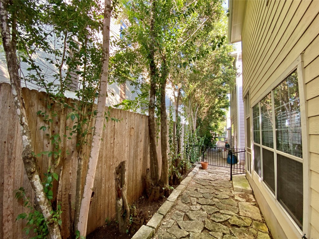 6704 Menchaca Road, Unit 8 Austin, TX 78745 - Photo 16 of 39 a view of a pathway of a house with a fountain