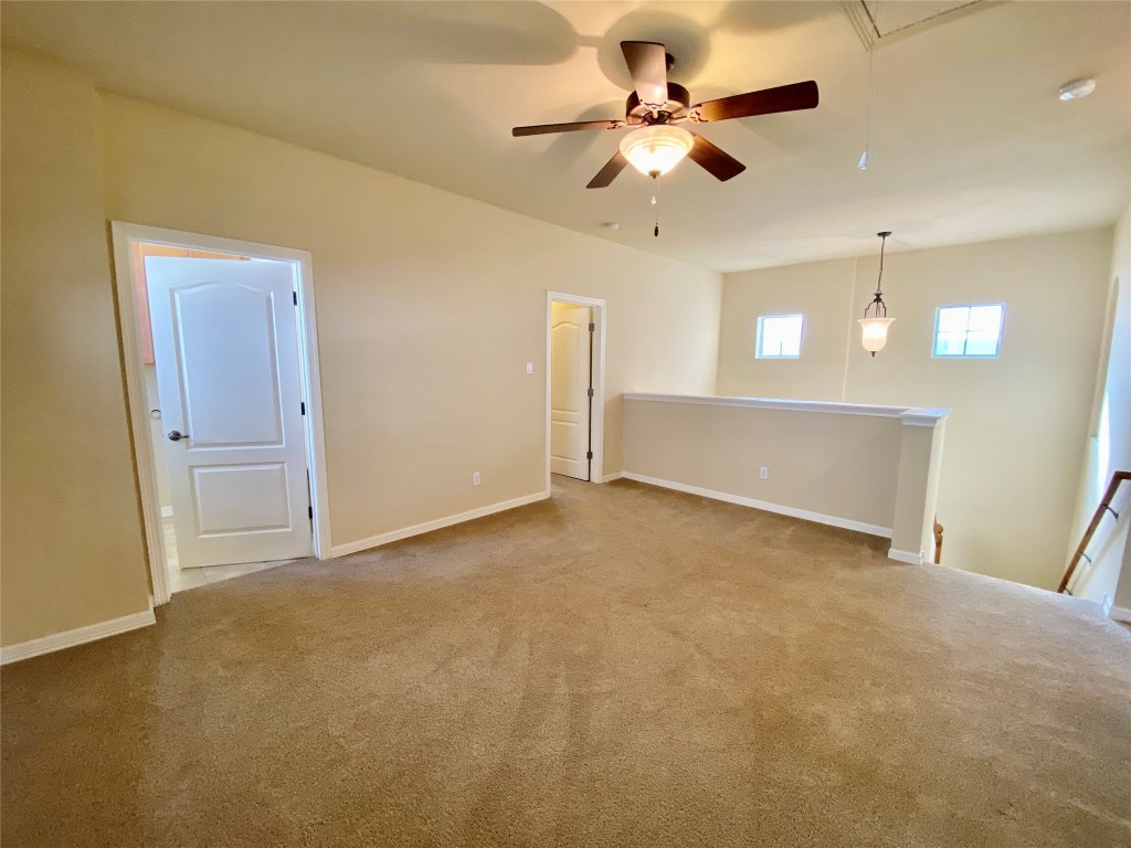 6704 Menchaca Road, Unit 8 Austin, TX 78745 - Photo 18 of 39 an empty room with a ceiling fan and a window