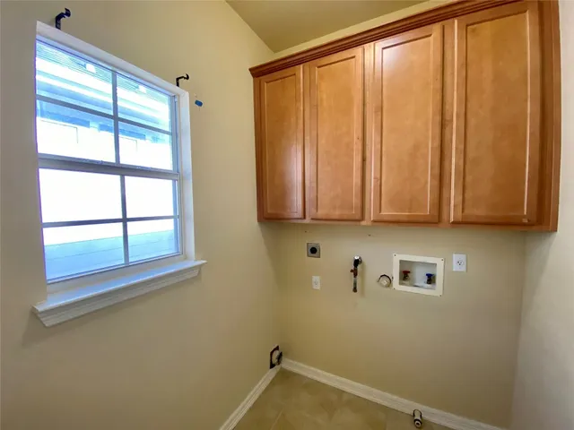 an empty room with a ceiling fan and a window