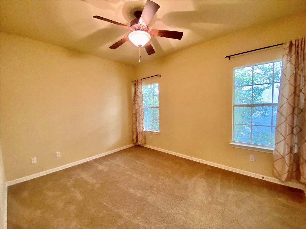 6704 Menchaca Road, Unit 8 Austin, TX 78745 - Photo 26 of 39 an empty room with a window and a fan