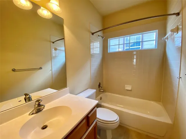 a bathroom with a sink mirror toilet and bathtub