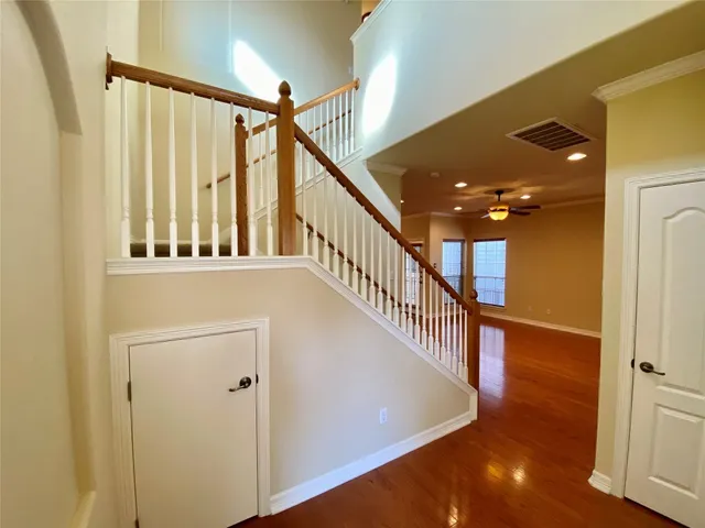 a view of entryway and hall with wooden floor