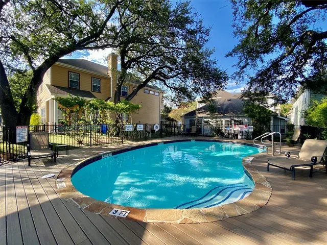 a view of a house with swimming pool and sitting area