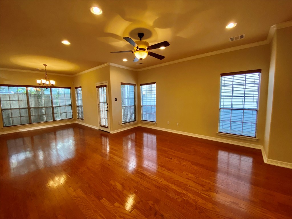 6704 Menchaca Road, Unit 8 Austin, TX 78745 - Photo 5 of 39 a view of an empty room with wooden floor and a window