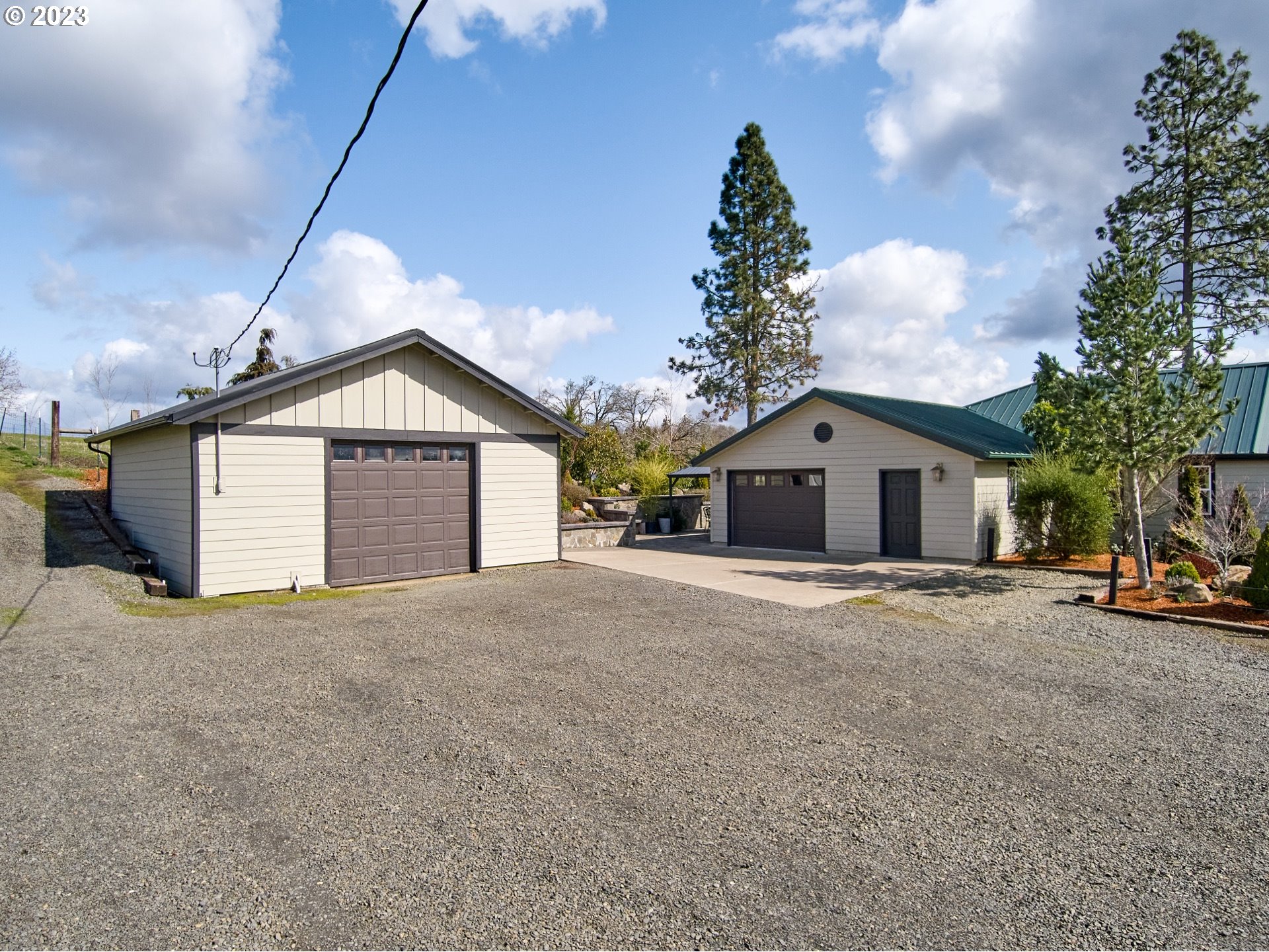 9953 South Wildcat Road Molalla, OR 97038 - Photo 4 of 41 a front view of a house with a yard and garage