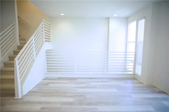 a view of entryway with wooden floor and stairs