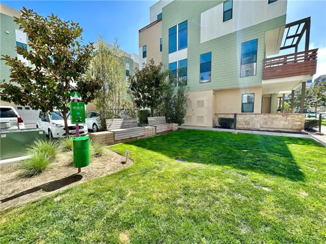 a view of a patio with couches table and chairs and potted plants