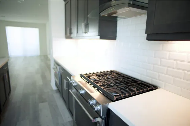 a kitchen with a stove and a refrigerator