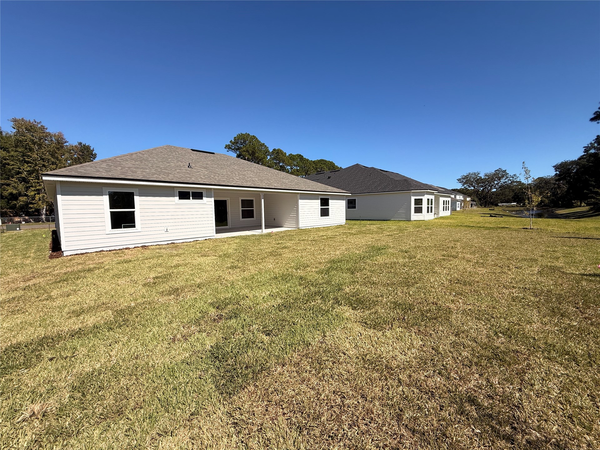 96076 Pirates Bluff Road Yulee, FL 32097 - Photo 19 of 22 a front view of a house with a yard