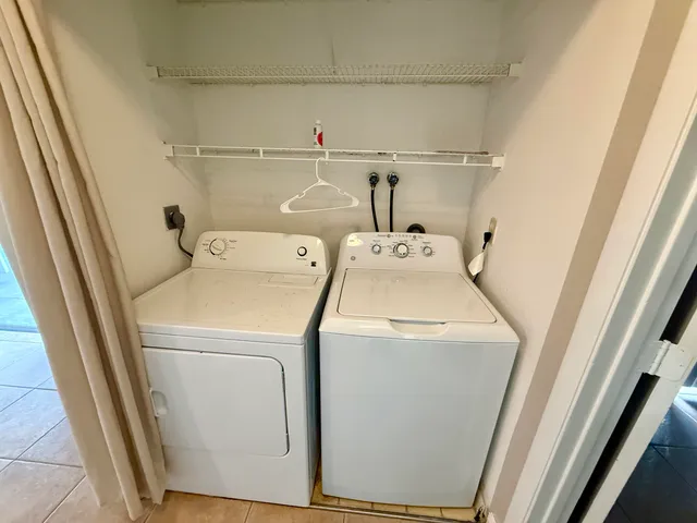 a living room with a bed furniture and a flat screen tv