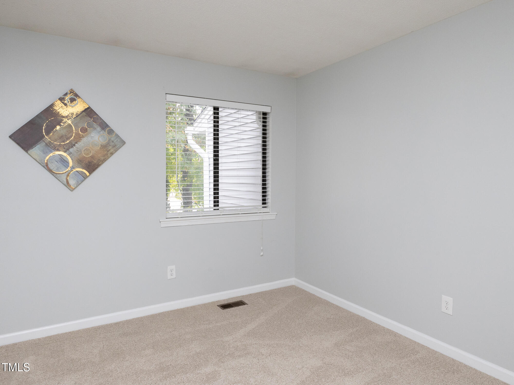 7353 Sandy Creek Drive Raleigh, NC 27615 - Photo 11 of 13 an empty room with a window