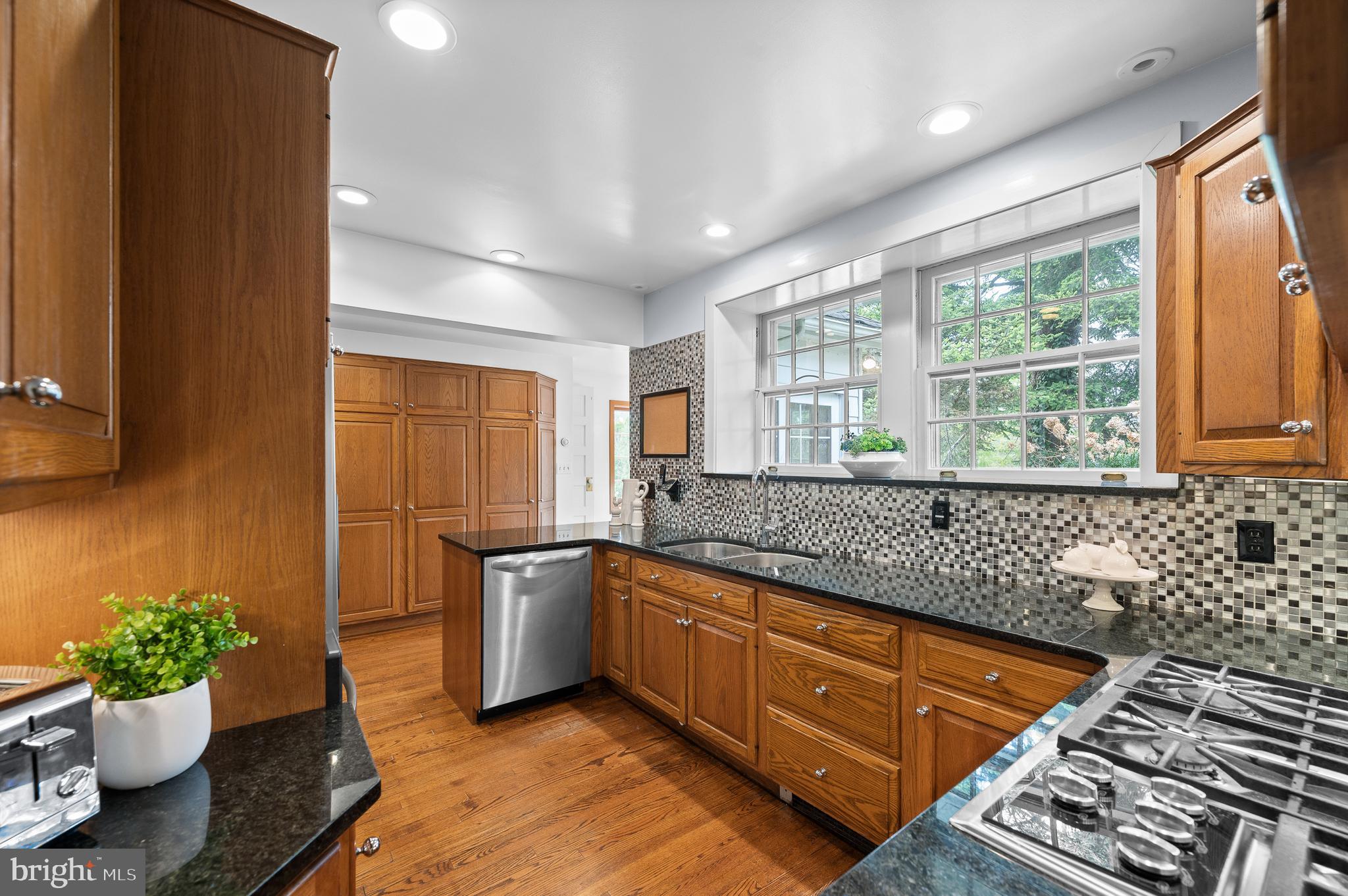 3 Canterbury Lane Wayne, PA 19087 - Photo 22 of 57 a kitchen with stainless steel appliances kitchen island granite countertop a sink and a wooden cabinets