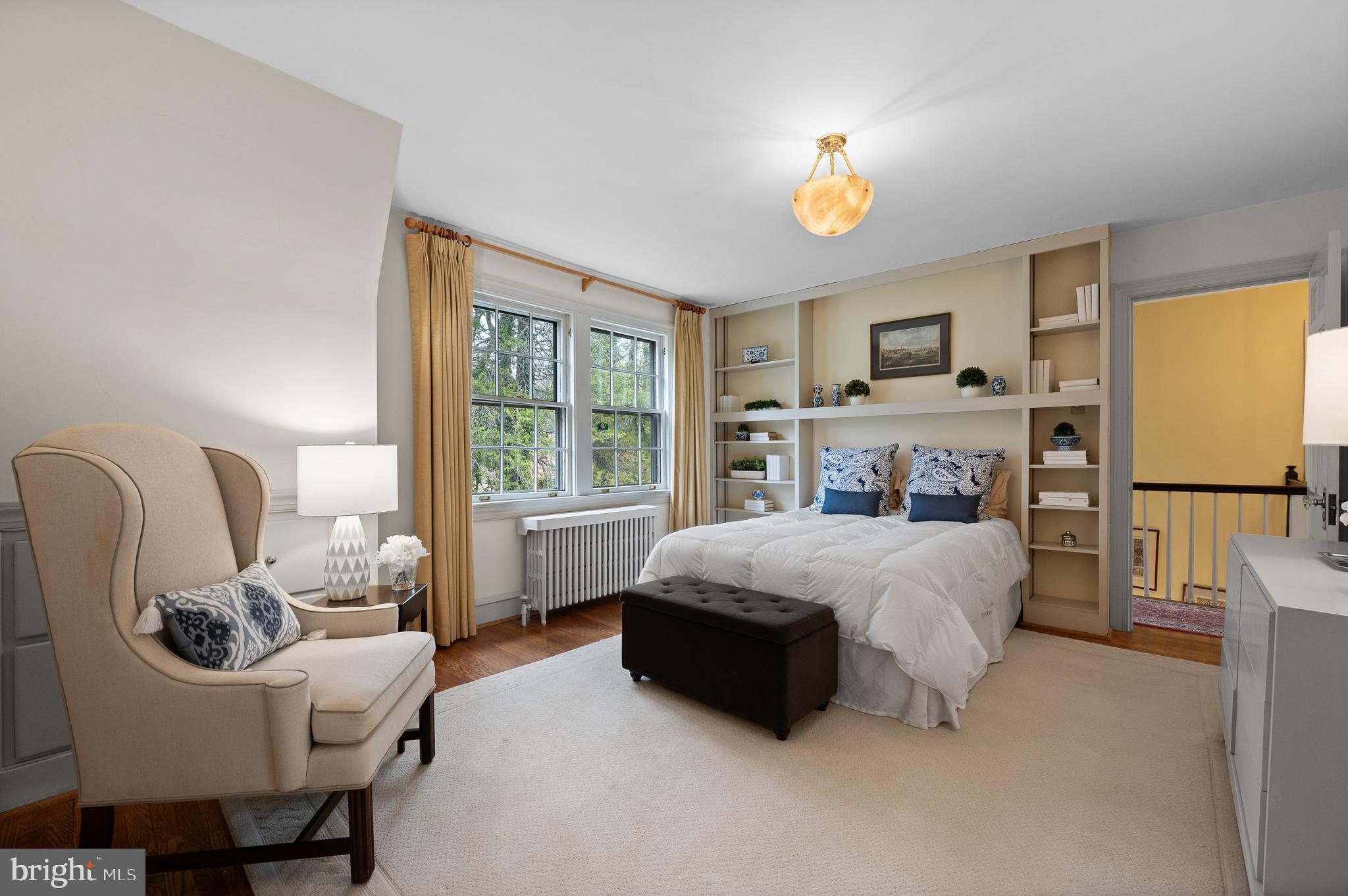 3 Canterbury Lane Wayne, PA 19087 - Photo 39 of 57 a bedroom with a bed a chandelier a mirror and a window
