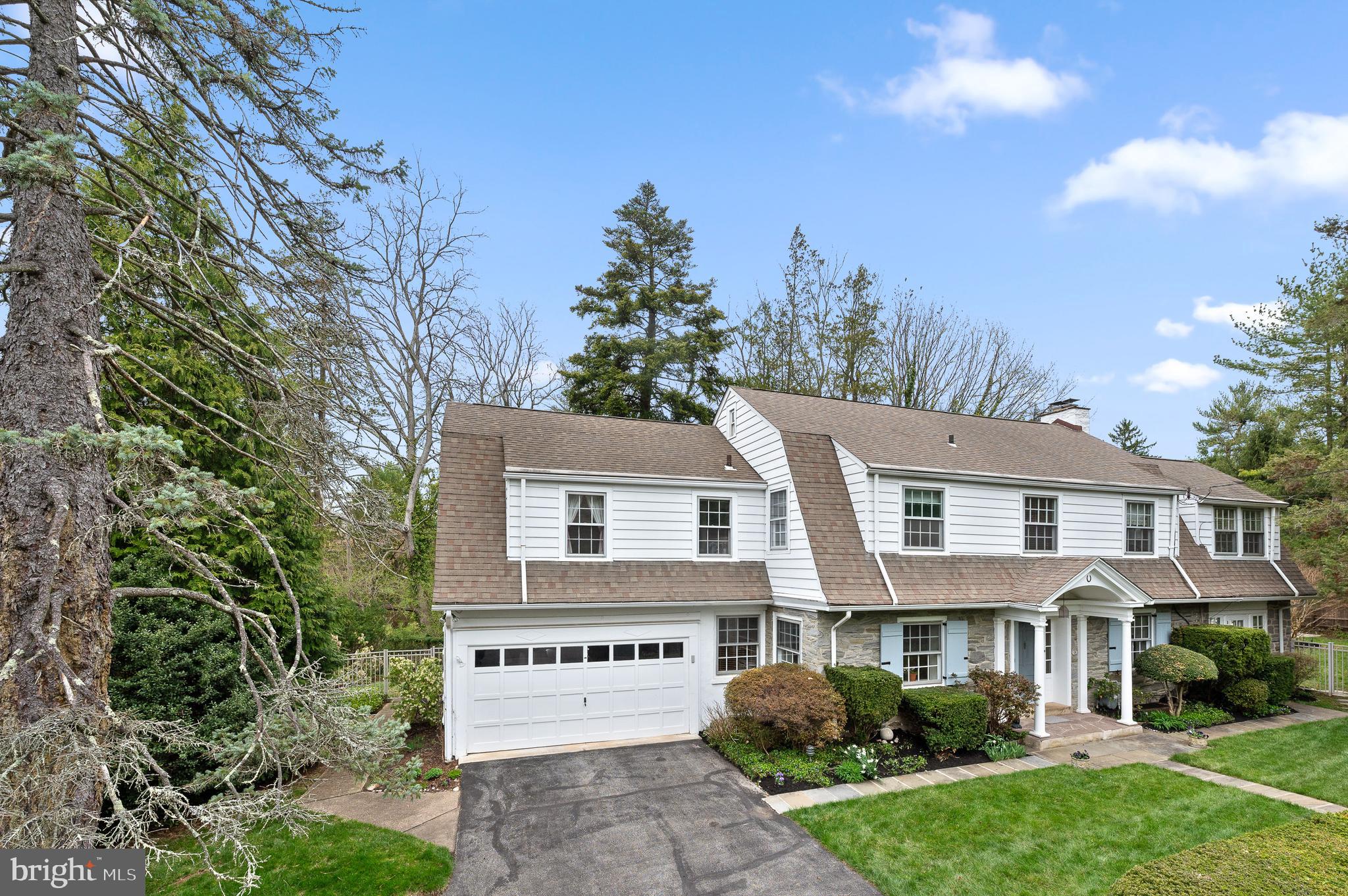 3 Canterbury Lane Wayne, PA 19087 - Photo 4 of 57 a view of a white house with a yard and potted plants