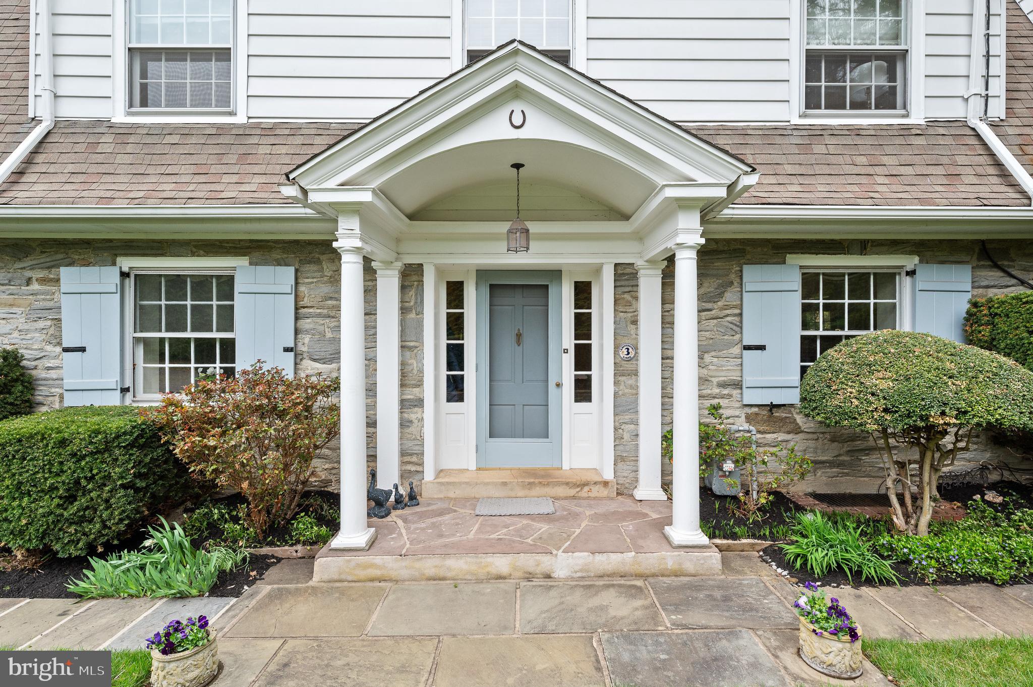 3 Canterbury Lane Wayne, PA 19087 - Photo 7 of 57 a view of a brick house with large windows and plants