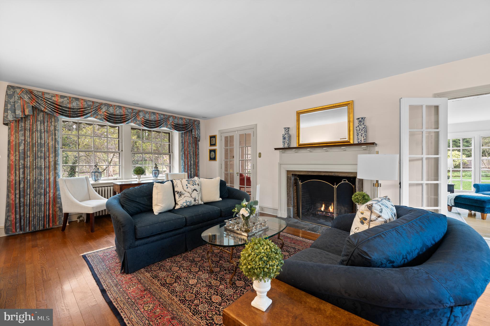 3 Canterbury Lane Wayne, PA 19087 - Photo 9 of 57 a living room with furniture large window and a fireplace