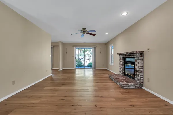 a view of a room with wooden floor and chandelier