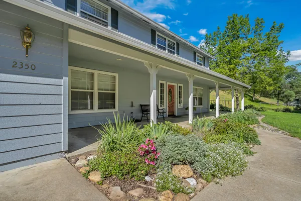 a front view of a house with a garden