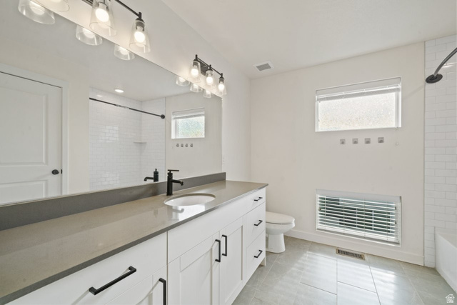70 East Weekes Way Clearfield, UT 84015 - Photo 9 of 25 Full bathroom featuring vanity, bathing tub / shower combination, and light tile patterned floors