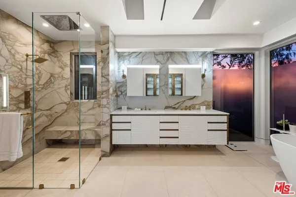 a bathroom with a double vanity sink and mirror