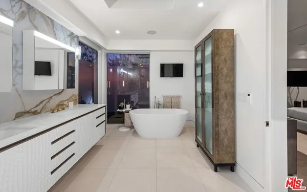 a bathroom with a granite countertop sink mirror and bathtub