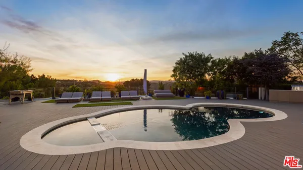 a view of a swimming pool with a yard