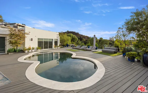 a view of swimming pool with seating space
