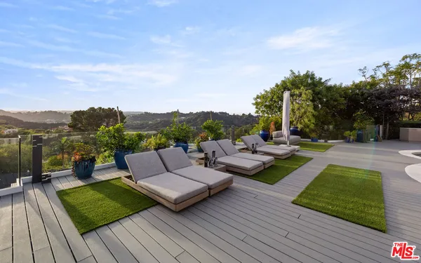 a view of a couches in patio of back yard