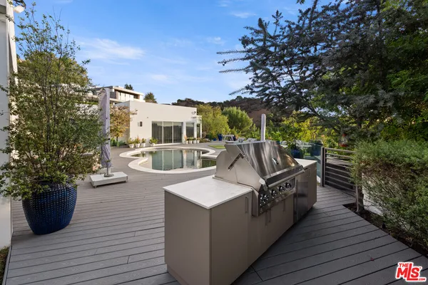 a view of a house with deck and patio