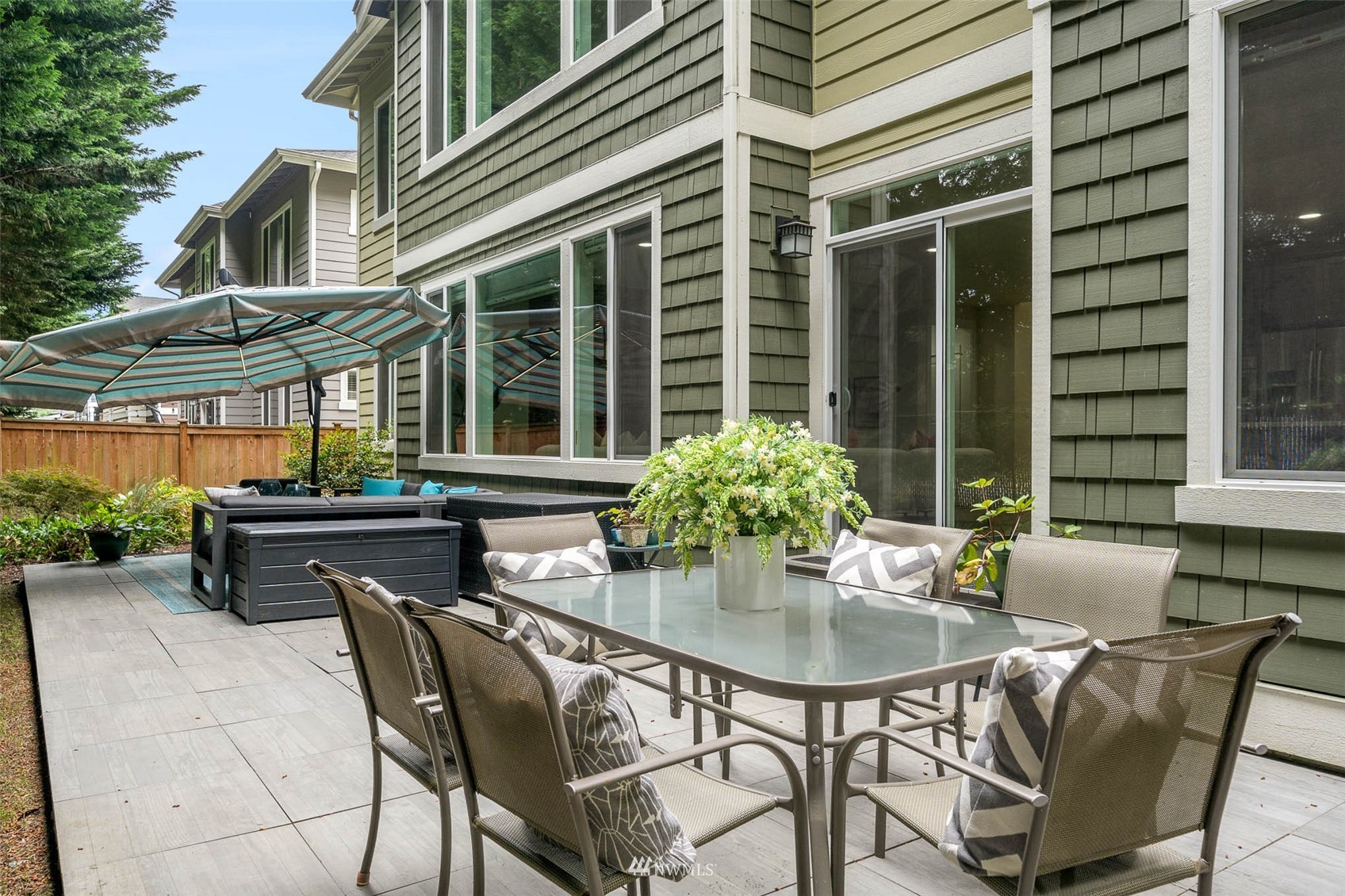 10133 Northeast 147th Street Bothell, WA 98011 - Photo 32 of 39 a patio with a table and chairs and potted plants