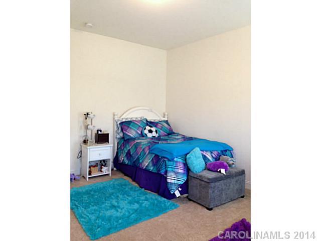 5000 Fallondale Road, Unit 885 Waxhaw, NC 28173 - Photo 12 of 16 a bedroom with a bed and a window