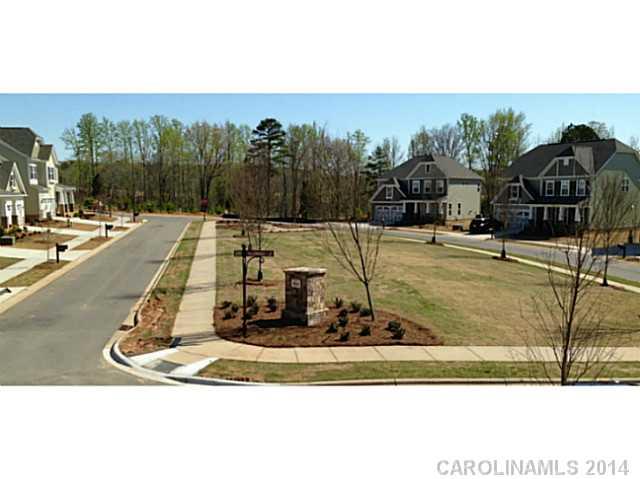 5000 Fallondale Road, Unit 885 Waxhaw, NC 28173 - Photo 16 of 16 a view of a swimming pool with a bench and trees in the background