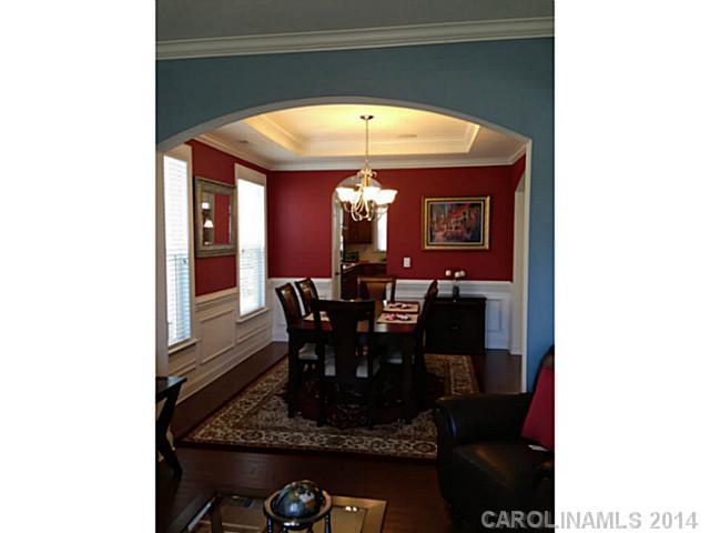 5000 Fallondale Road, Unit 885 Waxhaw, NC 28173 - Photo 5 of 16 a view of a dining room with furniture and chandelier