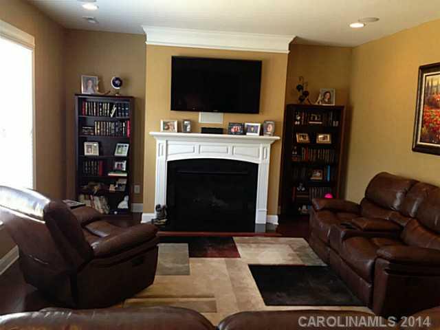 5000 Fallondale Road, Unit 885 Waxhaw, NC 28173 - Photo 6 of 16 a living room with furniture a flat screen tv and a fireplace