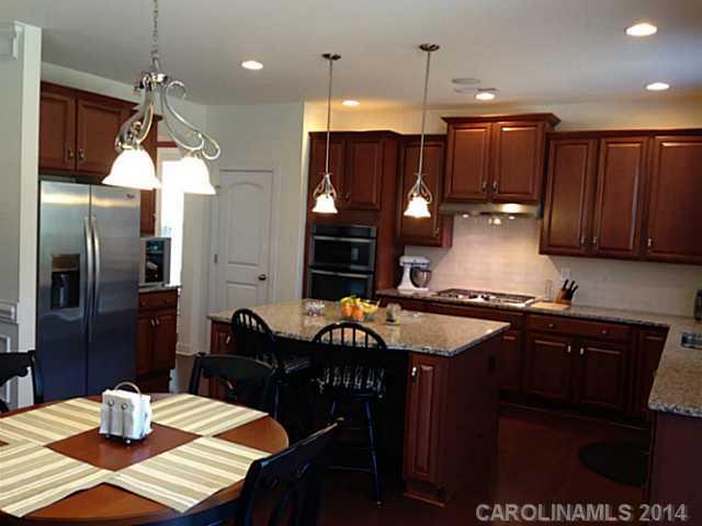 5000 Fallondale Road, Unit 885 Waxhaw, NC 28173 - Photo 7 of 16 a kitchen with a table and chairs in it
