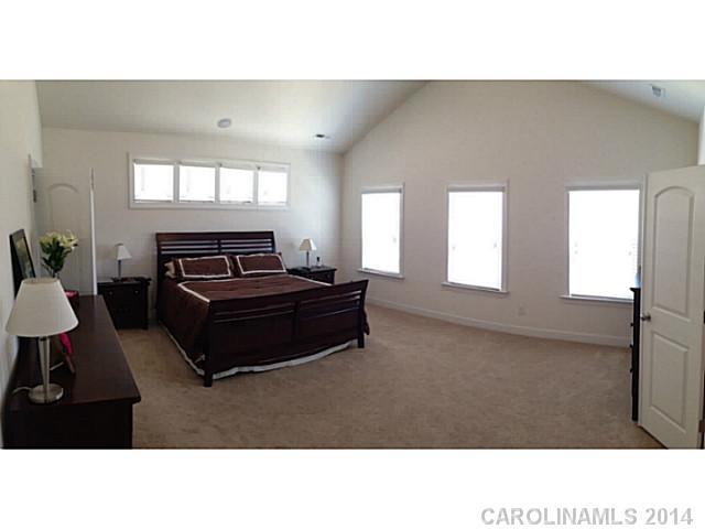 5000 Fallondale Road, Unit 885 Waxhaw, NC 28173 - Photo 9 of 16 a living room with furniture and a flat screen tv